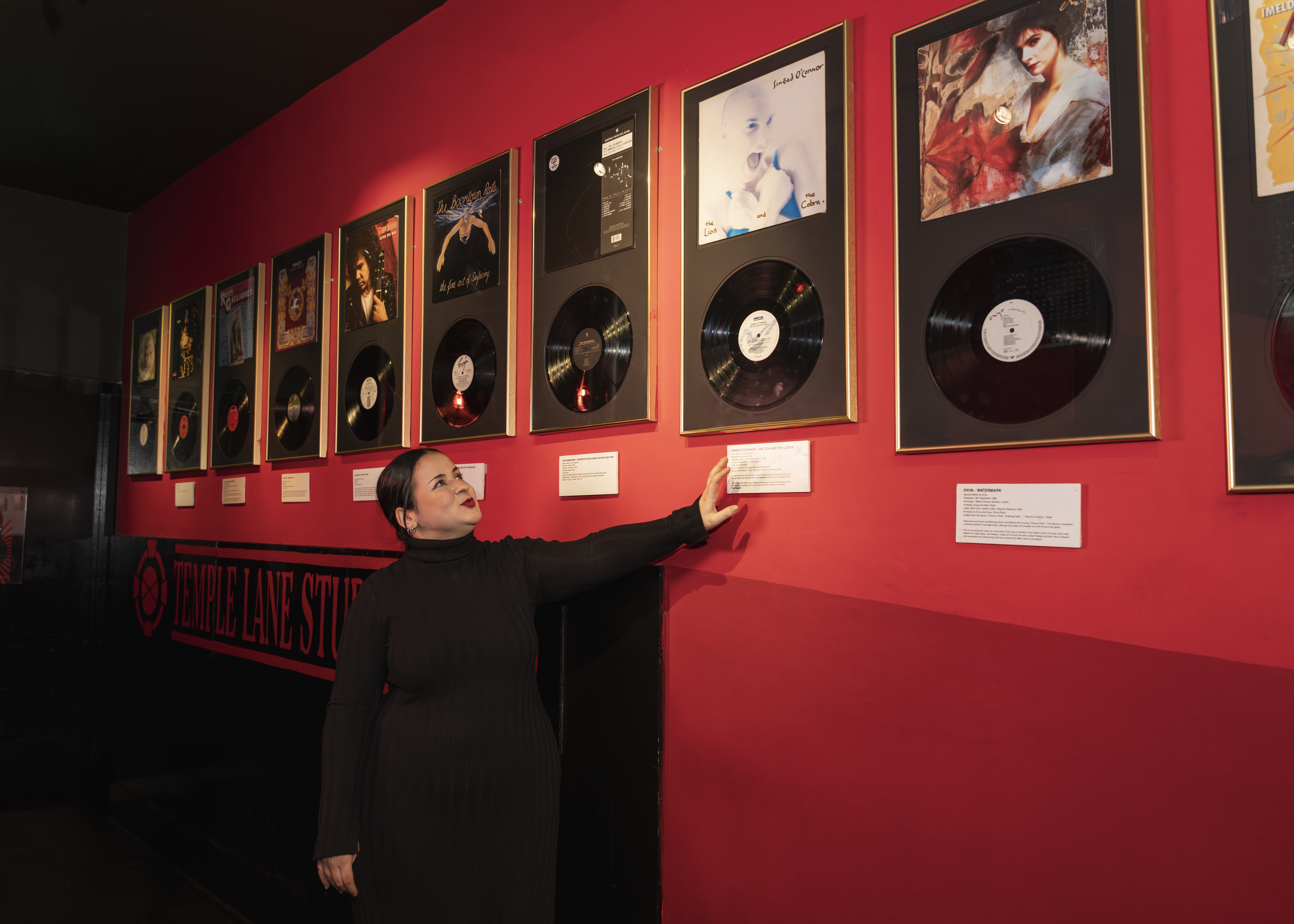 tour guide showing the vinyl's inside the Rock 'n' Roll Museum