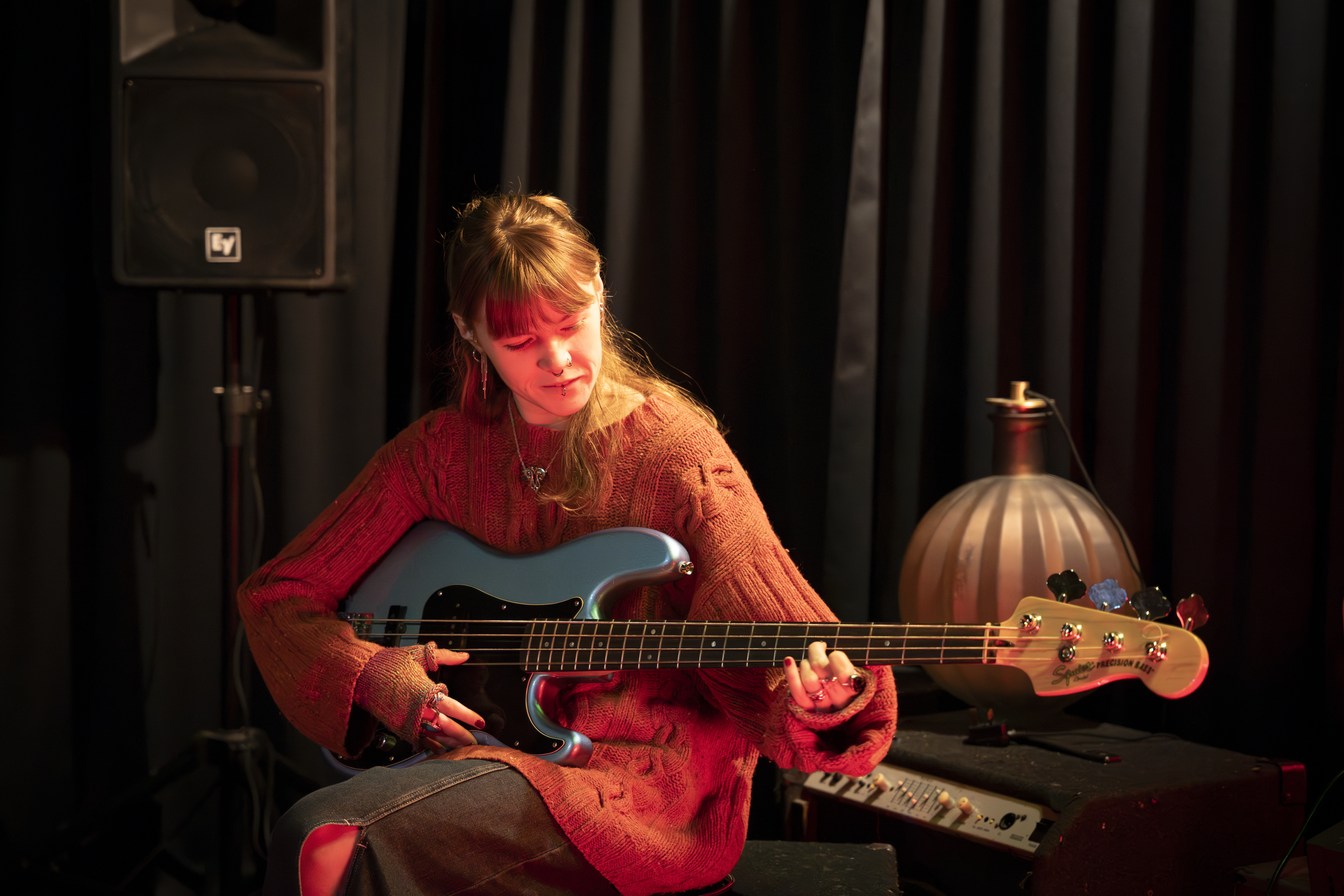 girl sitting playing a guitar